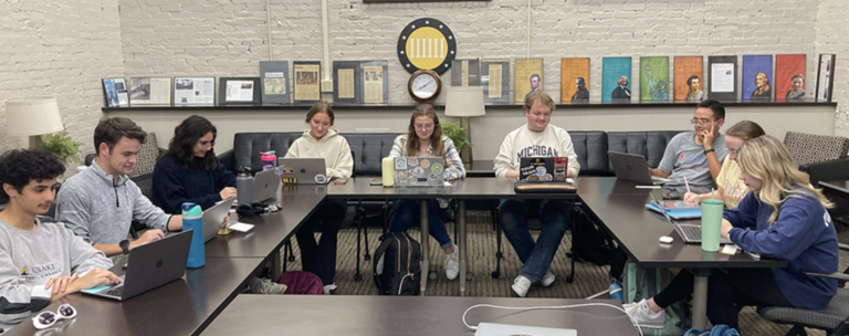 A group of students hard at work on their laptops.