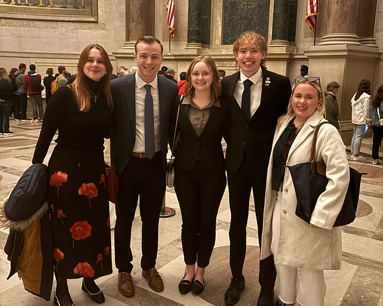 Five students smile together in Washington, DC