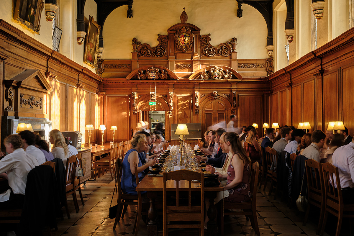 Students and faculty eat at long dining tables at Oxford University.