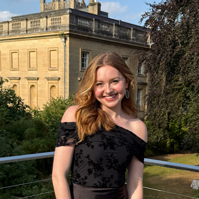 A student poses and smiles at Oxford University