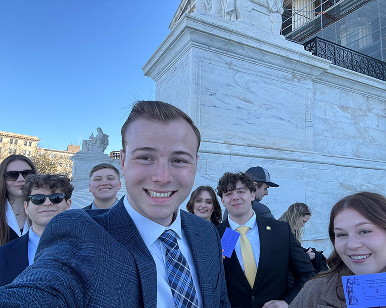 A group of students take a selfie outside in Washington, DC.