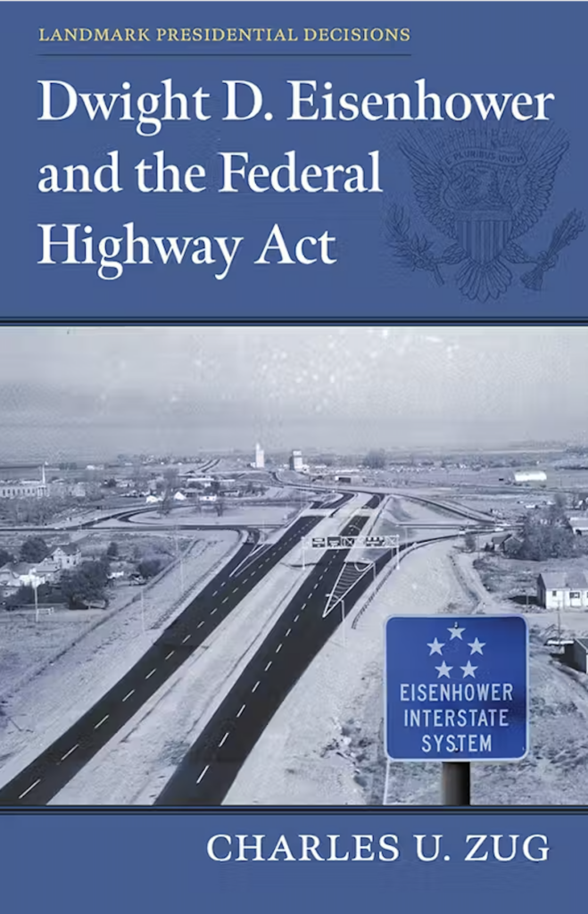 Cover for Dwight D. Eisenhower and the Federal Highway Act by Charles U. Zug. The cover is blue with a photo of the interstate in the wintertime.