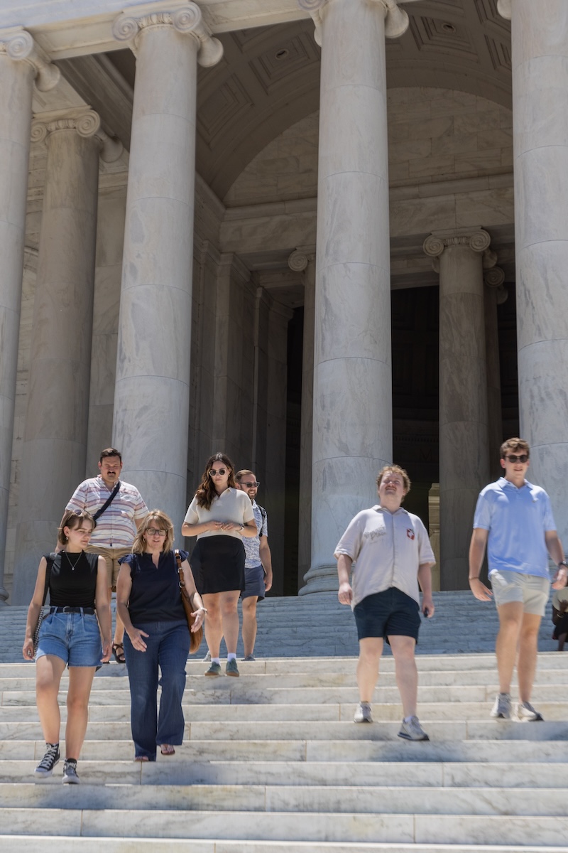 College students and their professor depart the Lincoln Memorial in DC.