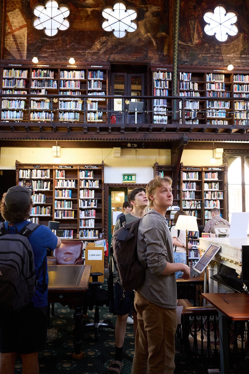A view of Corpus Christi College at Oxford through an iron latticed window