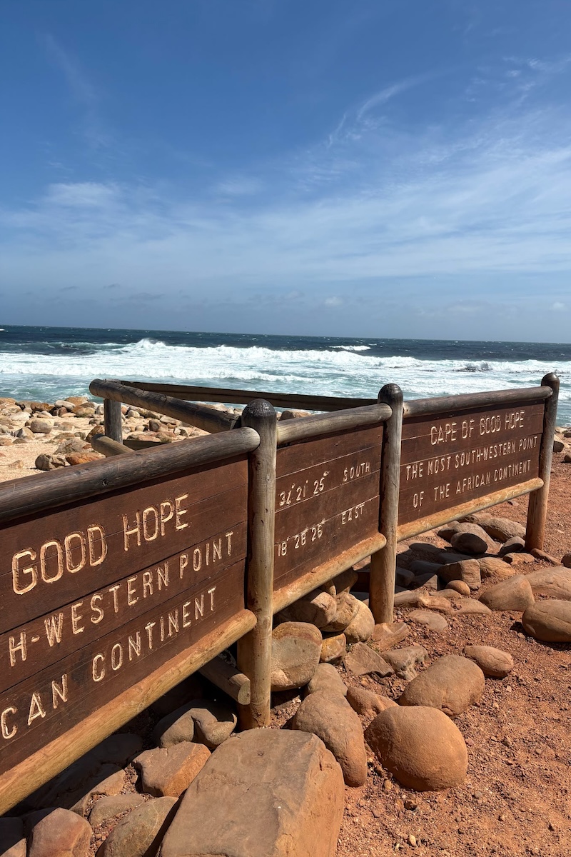 Students walking through the South African countryside, their backs to the camera