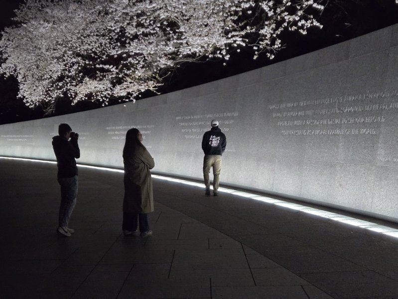 Three students gaze at the Martin Luther King Memorial in DC by night