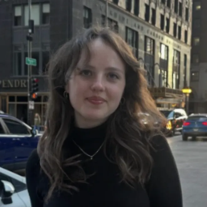A young woman poses for a picture on a New York street corner.