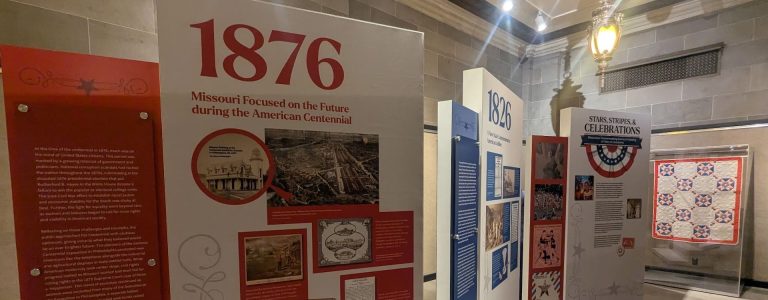 Placards and a historic quilt as part of a public exhibition on Missouri and the 250th US anniversary