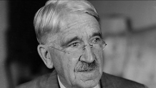 A portrait of John Dewey, bespectacled with white hair